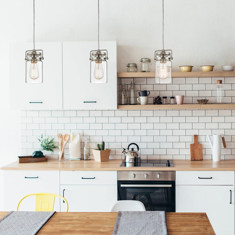 Three Kichler Brinley Brushed Nickel Mini Pendant Ceiling Light Over a Table in a Kitchen 